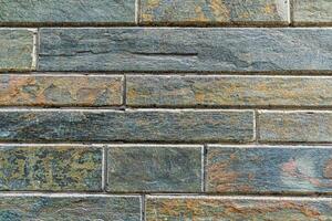 A seamless brick wall texture in shades of dark green and black. This high-resolution image is perfect for use as a background for websites, presentations, or print projects. photo