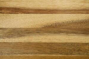 This image showcases a close-up of a textured light brown wood grain background with horizontal planks and natural stripes, perfect for design projects needing a rustic or organic touch. photo
