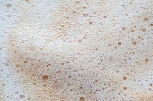 A white background with a brown swirl of foam photo