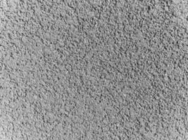 A grey surface with many small rocks photo