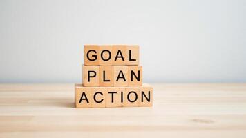 A stack of wooden blocks with the words goal plan action written on them. Generate Ai photo