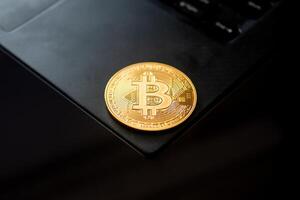 A gold coin with the Bitcoin on it photo