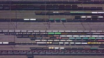 Aerial view of Railway sorting station and A lot of wagons at a railway. Drone flies over railway tracks. 4k quality video
