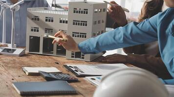 A group of people working on a model of a building video
