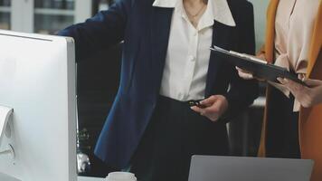 Two businesswomen in an office discussing something video