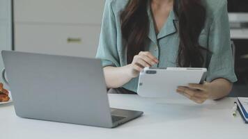 A woman is using a tablet computer at a desk video