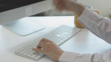 A person typing on a computer keyboard video