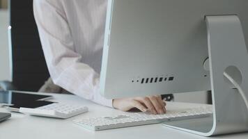 A person typing on a computer keyboard video