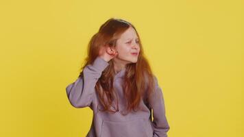 Child girl kid trying hear you looking confused and frowning, keeping arm near ear for louder voice video