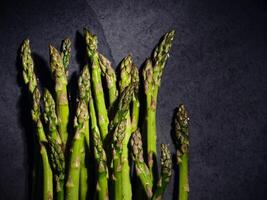 Green asparagus on gray marble surface photo