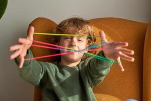 Content boy showing string on fingers photo