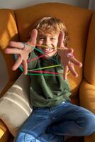 Happy kid enjoying string game at home photo