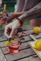 Young hipster man serving drink in glass photo