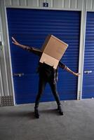 Faceless carefree person with box on head photo