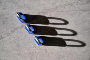 Set of secure locks placed on concrete floor photo