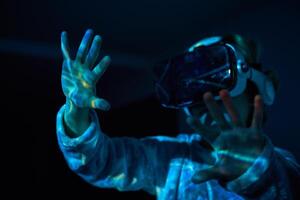 Anonymous child touching imaginary screen in VR glasses photo