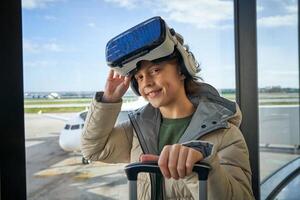 Content child adjusting VR headset and smiling at camera in airp photo