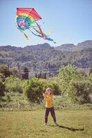 Cheerful boy playing with kite photo