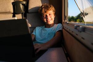 Delighted boy browsing netbook in RV photo