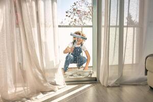 Anonymous kid cleaning windows at home photo