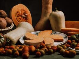 Composition of pumpkin and butternut squash and ripe tomatoes photo