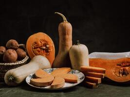 Nutmeg pumpkin slices on plate and butternut squash photo