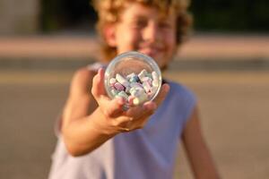 Child with pile of chalks in jar photo