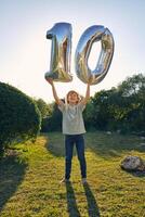 Happy boy with balloon number 10 photo