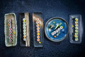 Set of various types of sushi on blue marble table photo