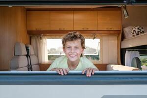 Delighted boy behind caravan window photo