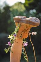 Crop person wearing boot with flowers photo