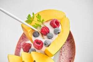 Appetizing dessert made of papaya and berries photo