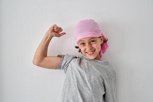 Joyful little boy smiling brightly and showing bicep photo