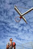 Basketball player preparing to throw ball into ring photo