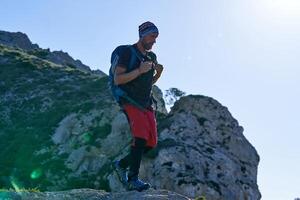 Mature man with backpack in mountains photo