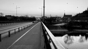 Serenity at dusk on an empty riverside bridge photo