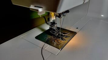 Creative sewing moment with machine and thread in action photo