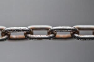Metal chain links connecting in a close-up view of strength. photo
