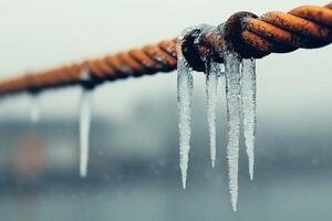 Beautiful ice formations on a weathered metal cable. photo