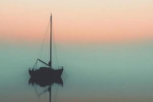 Serenity of a sailboat at dawn by the tranquil waters. photo
