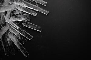 Ice formations creating a striking contrast on black surface. photo