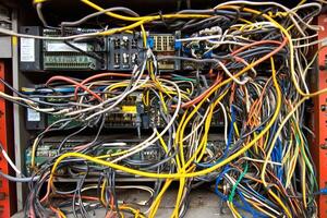 Complex network of colorful cables in a tech setting. photo