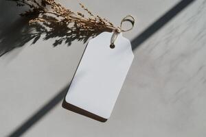 Blank tag illuminated by gentle sunlight on a table. photo