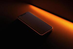 Modern smartphone illuminated by warm orange light on a sleek surface. photo