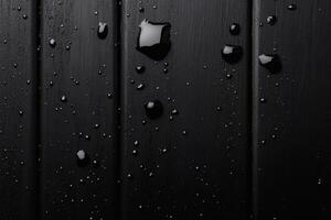 Shimmering droplets on dark surface create a mesmerizing contrast of light and shadow. photo