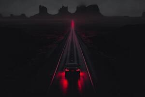 Nighttime journey through a mysterious desert landscape at dusk. photo