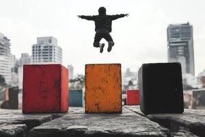 Child Jumps Between Colorful Blocks in Urban Playground During Daytime Activity. photo
