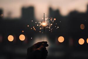 Celebratory Sparkler Held Against a Blurred City Backdrop During Twilight. photo