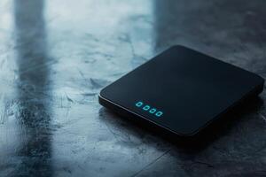 Digital scale rests on a sleek surface photo