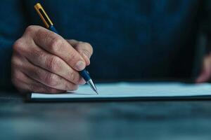 Capturing thoughts on paper through the gentle movement of a pen during a serene moment of inspiration at a quiet workspace photo